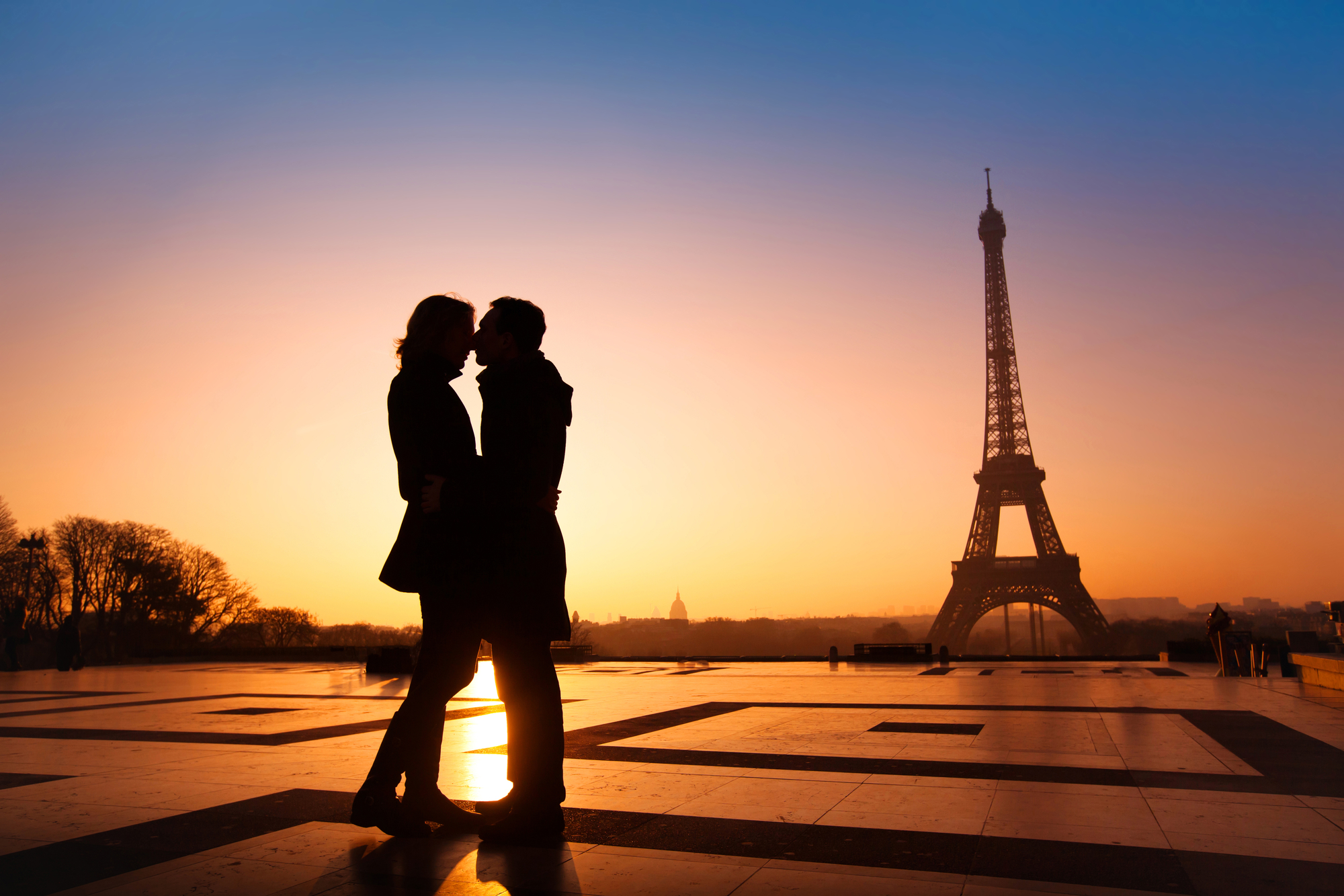 loving couple kissing on Eiffel Tower background, Paris, France.